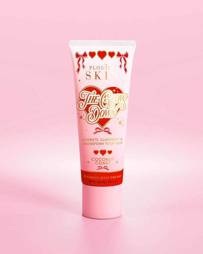 Pink tube of P.Louise The Glow Down shimmer body cream in coconut coast scent against a pink background