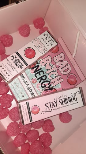 Customer's Bad Bitch Energy Lip Duo packaging displayed in a box with pink, raspberry-shaped candies.