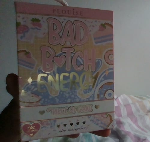 Customer holding the pretty pink packaging for the Bad Bitch Energy Lip Duo.
