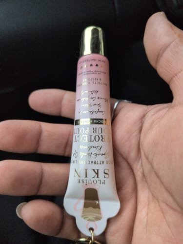 Customer holding the pink and white Bad Bitch Energy Lip Duo tube, showing the keyring attachment.