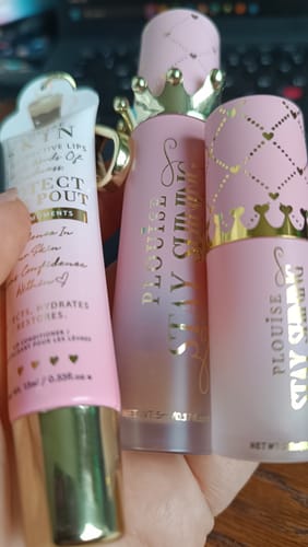 Reviewer holding the P.Louise Lip Duo products, showing the decorative pink and gold packaging.