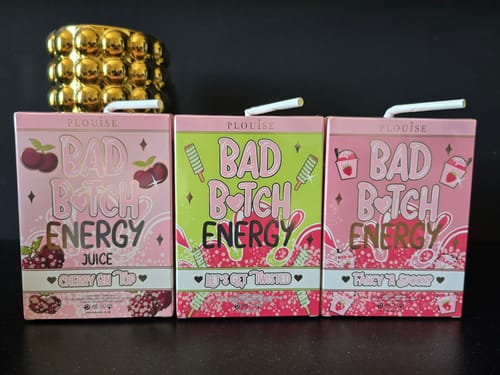 Customer's three Bad Bitch Energy Lip Duo boxes, styled to look like colorful juice cartons.