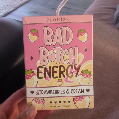 Customer holds the pink, carton-style packaging for the Bad Bitch Energy Lip Duo in Strawberries & Cream.