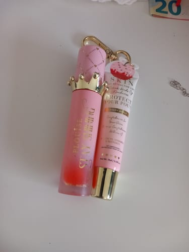 Reviewer's P.Louise Bad Bitch Energy Lip Duo in pink packaging with a gold crown cap on a keychain.
