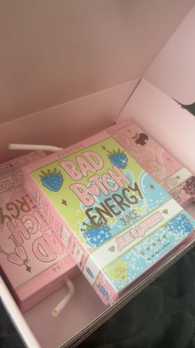Reviewer's unboxing photo of the Bad Bitch Energy Lip Duo, showing the colorful juice box packaging.